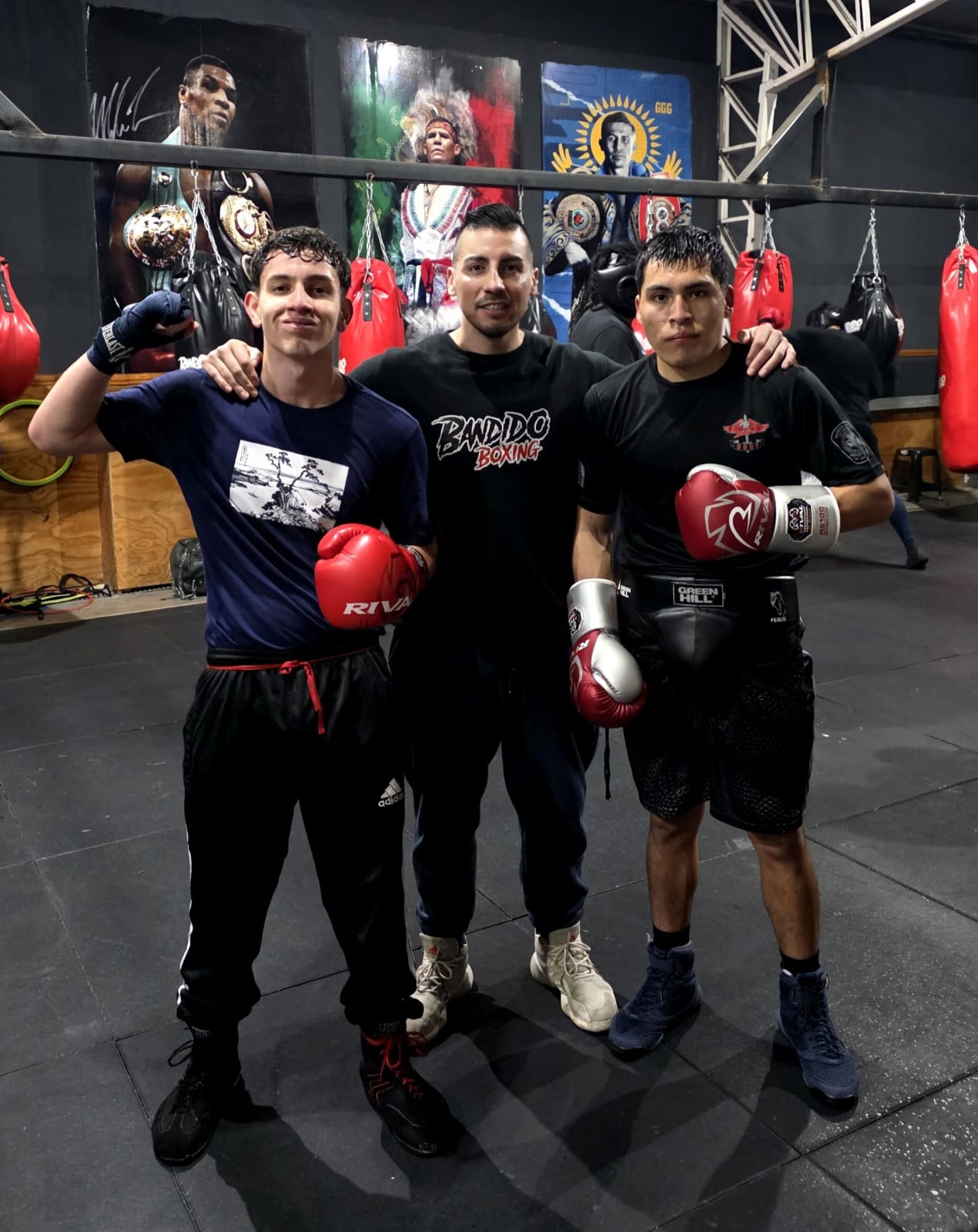Alumnos de Bandido Boxing con guantes junto a los sacos de boxeo